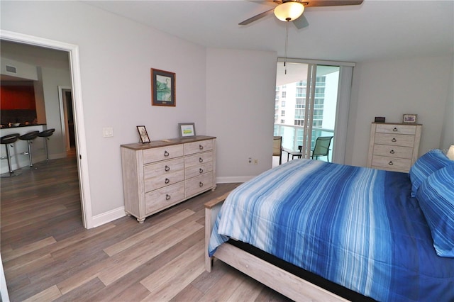 bedroom with ceiling fan and wood-type flooring