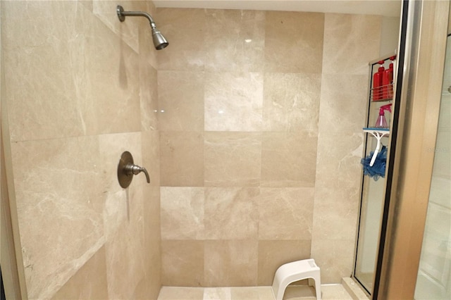 bathroom with a shower with door