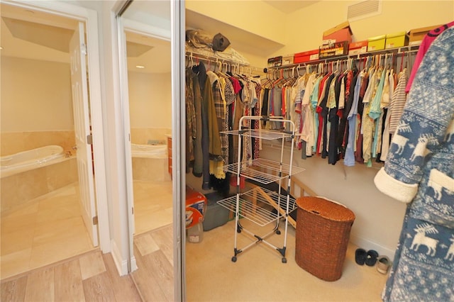 walk in closet featuring light tile floors