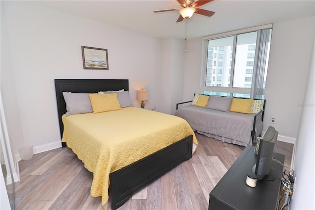 bedroom featuring light hardwood / wood-style floors and ceiling fan