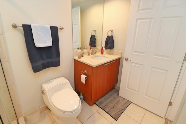 bathroom with vanity, tile flooring, and toilet