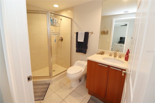 bathroom with toilet, large vanity, tile floors, and a shower with shower door