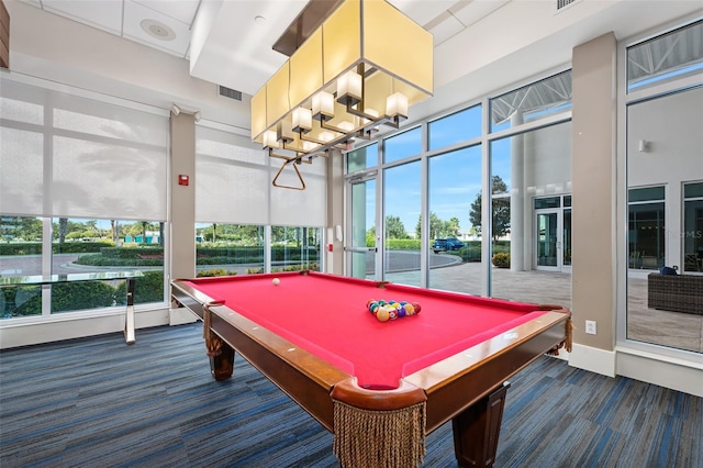 rec room with dark carpet, pool table, a chandelier, and a healthy amount of sunlight