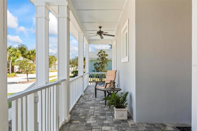 balcony with a porch and ceiling fan