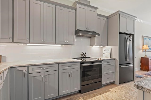 kitchen with range with electric cooktop, ventilation hood, tasteful backsplash, gray cabinets, and stainless steel refrigerator