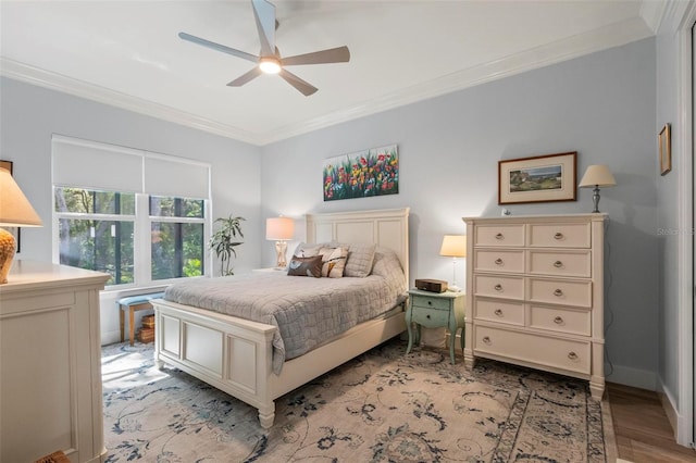 bedroom featuring light hardwood / wood-style floors, ornamental molding, and ceiling fan