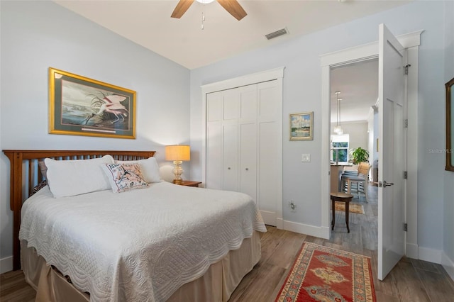 bedroom with a closet, ceiling fan, and light hardwood / wood-style flooring