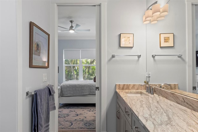 bathroom featuring crown molding, ceiling fan, and large vanity