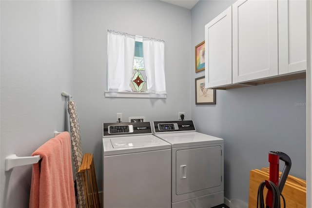 laundry area with electric dryer hookup, washer hookup, independent washer and dryer, and cabinets