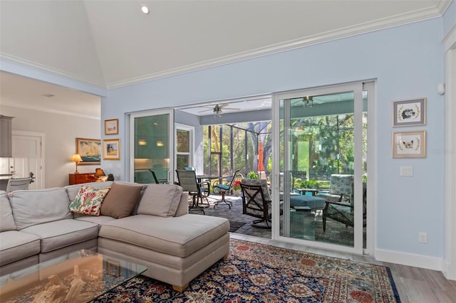 living room with plenty of natural light, high vaulted ceiling, ceiling fan, and hardwood / wood-style floors