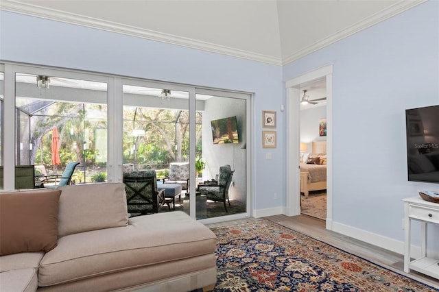 living room featuring crown molding, light hardwood / wood-style floors, and ceiling fan