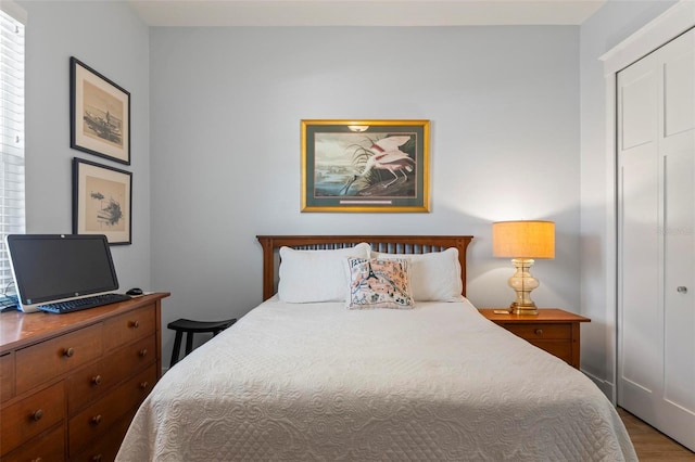 bedroom featuring hardwood / wood-style floors and a closet