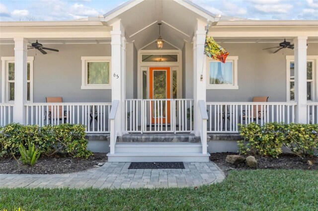 entrance to property featuring a porch and ceiling fan