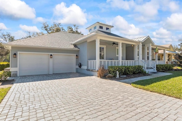 view of front facade featuring a porch, ceiling fan, and a garage