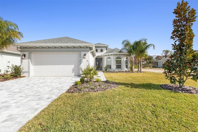 view of front of property with a front lawn and a garage