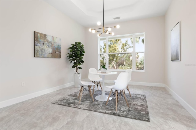 tiled dining space featuring a chandelier