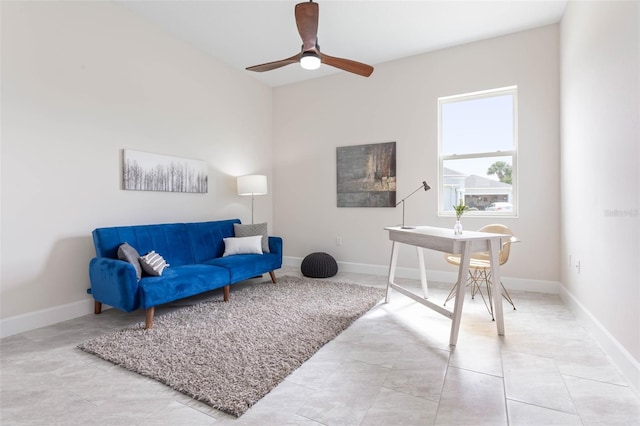 office area with light tile floors and ceiling fan