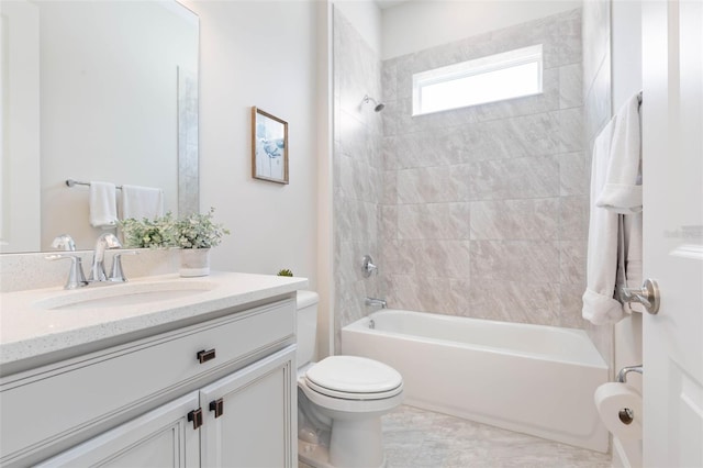 full bathroom featuring toilet, large vanity, tiled shower / bath combo, and tile flooring