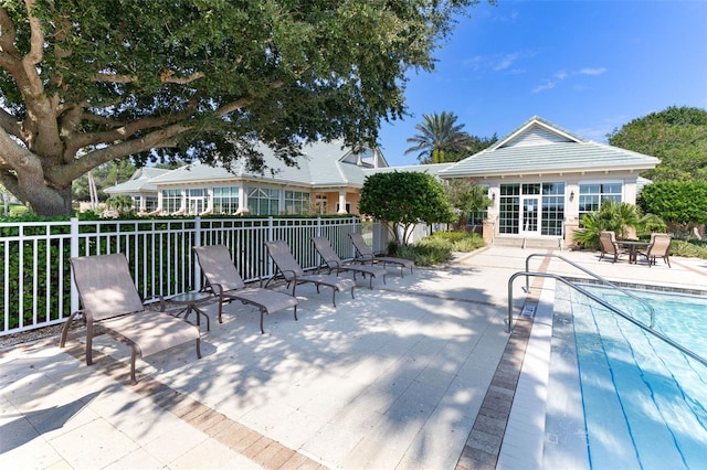 deck featuring a fenced in pool and a patio area