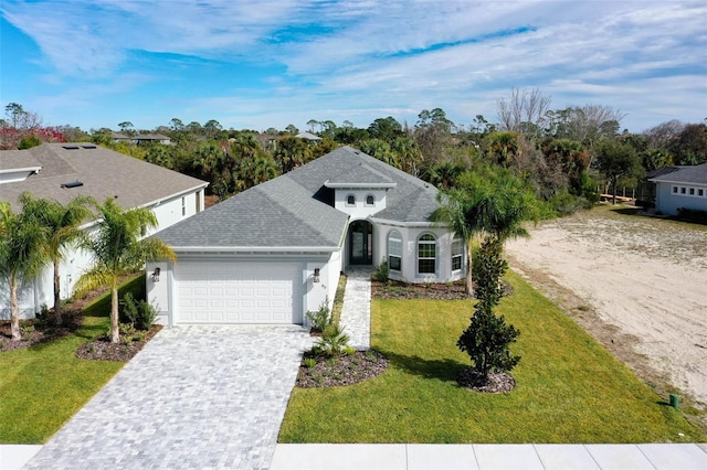 view of front facade with a front lawn and a garage