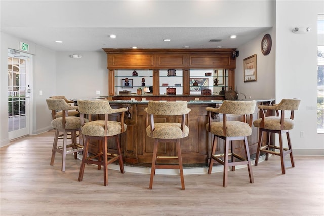 bar featuring light wood-type flooring