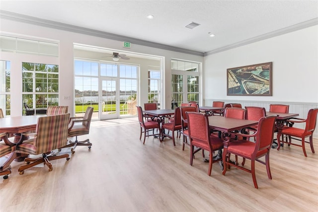 dining room featuring crown molding, french doors, ceiling fan, and light wood-type flooring