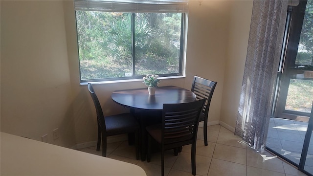 dining room featuring light tile flooring and plenty of natural light