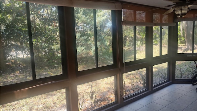 unfurnished sunroom featuring ceiling fan