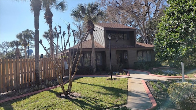 back of house with a lawn