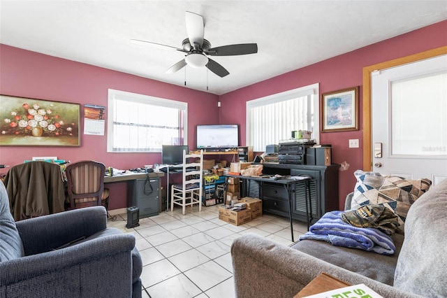 living room featuring light tile floors, ceiling fan, and a wealth of natural light