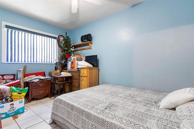 bedroom with light tile floors and ceiling fan