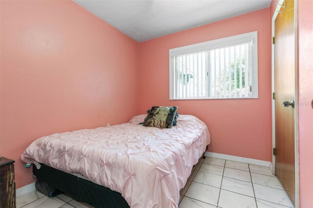 bedroom featuring light tile flooring