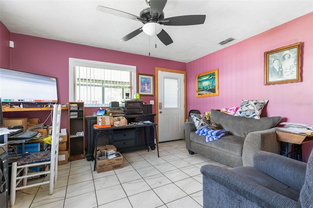 interior space featuring ceiling fan, light tile patterned flooring, and visible vents