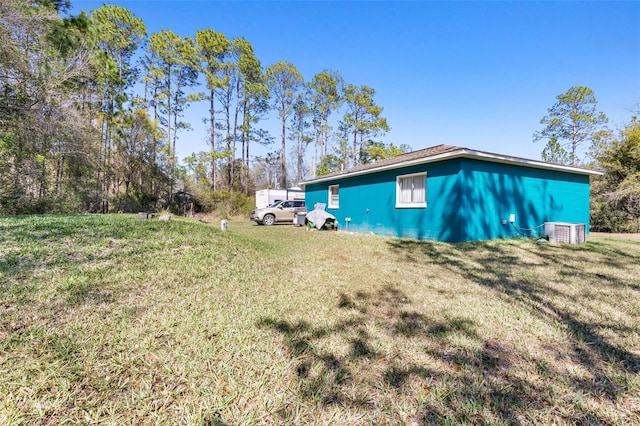 exterior space with a yard and central AC unit