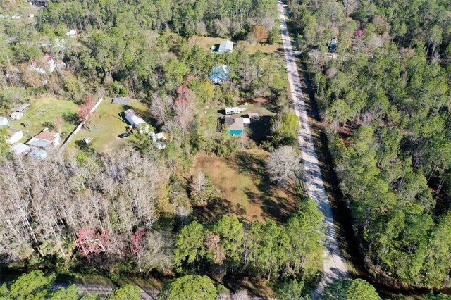 birds eye view of property with a view of trees