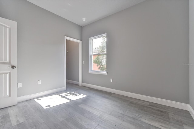 spare room featuring light hardwood / wood-style flooring