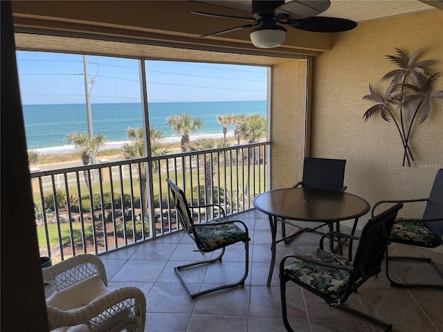 exterior space featuring a water view, ceiling fan, and a wealth of natural light