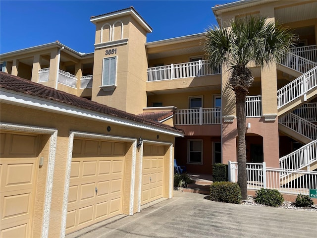 view of front of home featuring a balcony and a garage