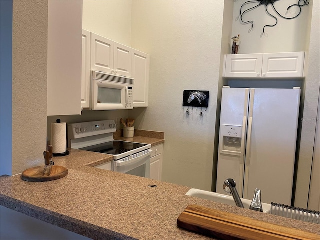 kitchen with white appliances and white cabinets