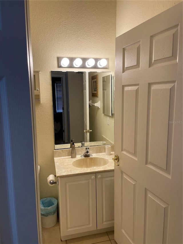 bathroom featuring vanity and tile flooring