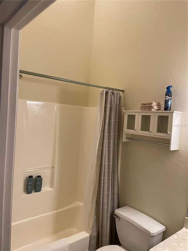 bathroom with toilet and shower / tub combo