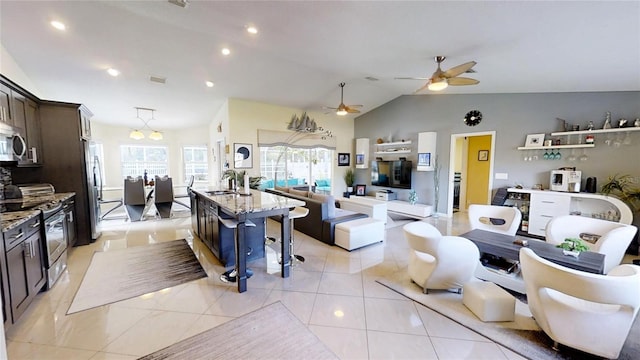 tiled living room featuring sink, ceiling fan, and lofted ceiling