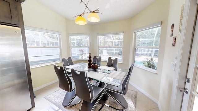 dining area featuring a notable chandelier and light tile flooring