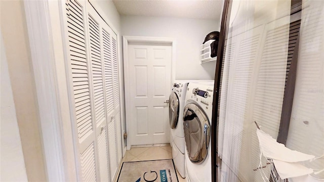 laundry room featuring light tile floors and separate washer and dryer