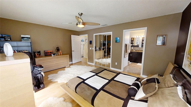 bedroom with ensuite bathroom, a closet, and ceiling fan