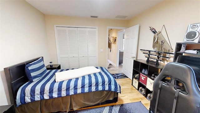 bedroom featuring a closet and light wood-type flooring