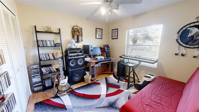 office with light hardwood / wood-style floors and ceiling fan