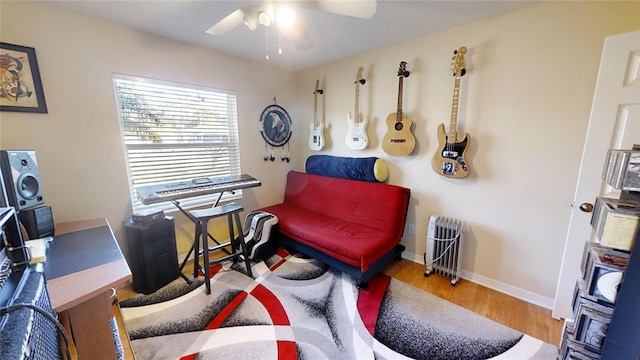 office with ceiling fan, radiator, and light hardwood / wood-style flooring