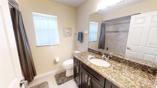 bathroom with toilet, vanity with extensive cabinet space, and tile flooring