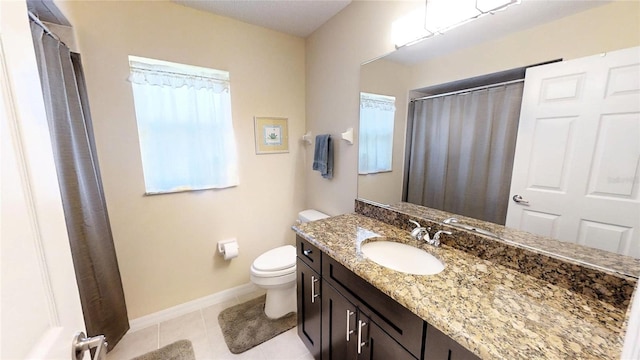 bathroom featuring toilet, tile floors, and vanity